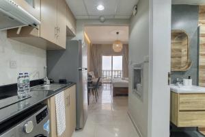 a kitchen with a sink and a counter top at CzechinProperties New Listing Sea View in Ras al Khaimah