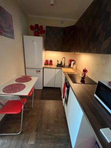 a kitchen with a white refrigerator and a table at apartament centrum RP in Katowice
