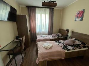 a hotel room with two beds and a desk at apartament centrum RP in Katowice