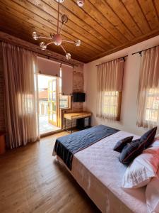 a bedroom with a large bed with a wooden ceiling at Oldies Hotel in Antalya