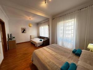 a bedroom with a large bed and a living room at Rooms Argo in Barcelona