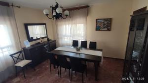 a dining room with a table and chairs and a mirror at Casa Jabero in Nívar