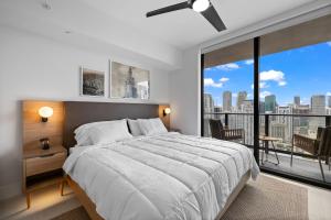 a bedroom with a large bed and a large window at Ultimate Elegance Studio with Panoramic City Views in Miami +31 photos