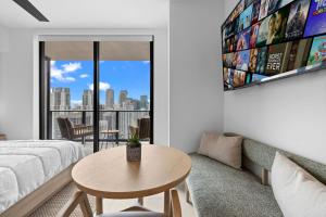 a living room with a couch and a table at Ultimate Elegance Studio with Panoramic City Views in Miami