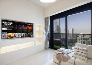 a living room with a tv and a large window at Luxury Apartment with Full Burj Khalifa and Downtown Views in Dubai