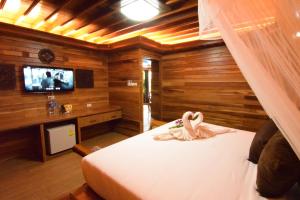 a bedroom with a bed and a tv in a room at Villa Habeebee in Ao Nang Beach