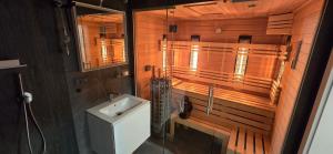 a bathroom with a shower and a sink and a mirror at Apartman so saunou, PRIMO Stary Smokovec in Smokovce +35 photos