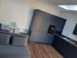 a living room with a couch and a kitchen at Cavehill Cottage in Belfast