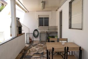a patio with a wooden table and chairs at Urban Beach - A Algarvia in Portimão +19 photos