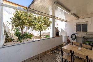 a large window in a room with a table and benches at Urban Beach - A Algarvia in Portimão