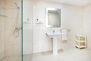 a bathroom with a sink and a glass shower at Hotel San Miguel in Altea +58 photos