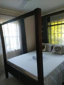 Postel nebo postele na pokoji v ubytování Palm Escape Diani Beach - Holiday Homes