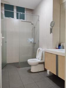 a bathroom with a toilet and a shower and a sink at Seaview Vacation Condo 3R3B 8Pax in Kampong Batu Maung