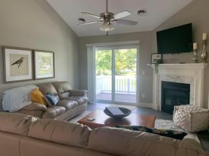 a living room with a couch and a fireplace at 2 Bedroom Condo with Office in Bettendorf