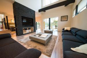 a living room with two couches and a fireplace at La Cachette in Hakodate