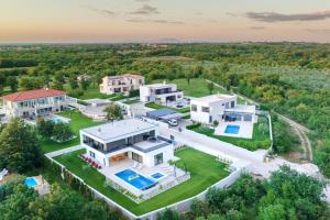 an aerial view of a large house with a pool at Villa MaEm in Juršići