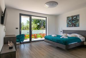 a bedroom with a bed and a large window at Villa MaEm in Juršići +39 photos