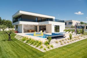 a villa with a swimming pool and a house at Villa MaEm in Juršići
