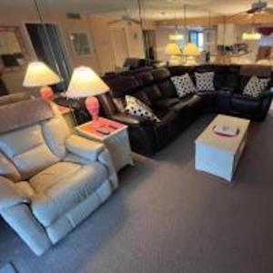 a living room with a couch and a table at 107 - 2/2 Poolside in Edgewater