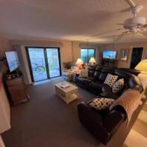 a living room with a couch and a table at 107 - 2/2 Poolside in Edgewater