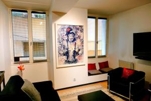 a living room with a large painting on the wall at Appart chic vieux nice 3 min de la plage in Nice