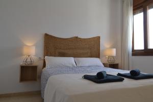 a bedroom with a bed with two towels on it at Penthouse City Center - Jerez in Jerez de la Frontera