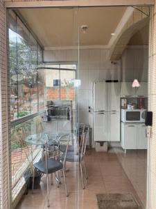 a kitchen with a table and chairs and a refrigerator at Apartamento 102 até 9 pessoas com garagem in Ipatinga