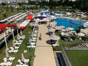 an outdoor pool with chairs and umbrellas at a resort at Central Apartment 2 in Sofia