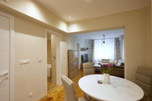 a room with a white table and a living room at Central Apartment 2 in Sofia