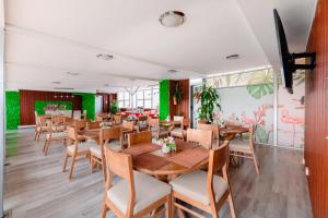 a restaurant with wooden tables and chairs at Hotel Parque 63 in Bogotá