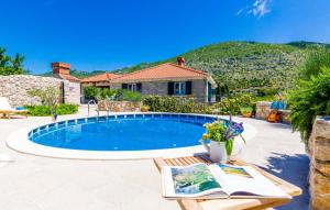 a swimming pool in a yard with a house at Villa Kate - outdoor pool, 4 bedrooms, free parking in Dubrovnik