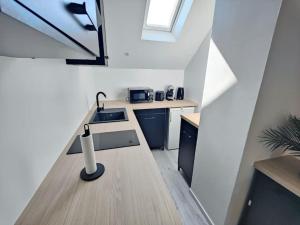 a kitchen with a sink and a counter top at Doris 3 in Châteaudun