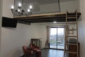 TV a/nebo společenská místnost v ubytování Chambre d'hôtes vue sur mer