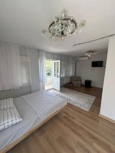 a bedroom with a large bed and a chandelier at Bike Hub Şile in Sile
