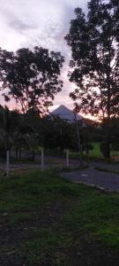 a cemetery with trees and a mountain in the distance at Serenity Rooms Arenal in Guayabal