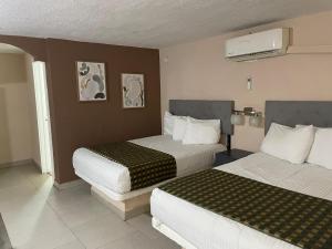 Voodi või voodid majutusasutuse Hotel Flamingo toas