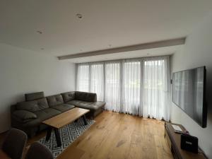 a living room with a couch and a table at PanoramaVista in Hof bei Salzburg