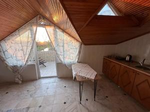 an attic room with a sink and a window at Bike Hub Şile in Sile