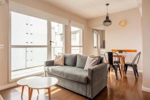 a living room with a couch and a table at Live & Enjoy Buenos Aires in Central Recoleta powered by Argenhost -A12J- in Buenos Aires