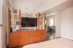 a living room with a flat screen tv on a entertainment center at Live & Enjoy Buenos Aires in Central Recoleta powered by Argenhost -A12J- in Buenos Aires