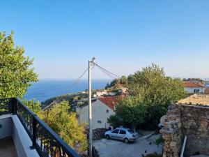 a view of the ocean from the balcony of a house at İncirci Stone House, Sazlı Köyü in Ayvacık