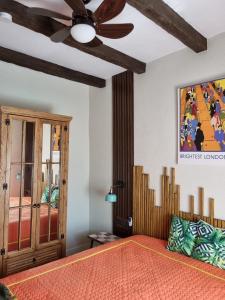 a bedroom with a bed and a ceiling fan at İncirci Stone House, Sazlı Köyü in Ayvacık