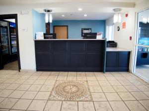 a waiting area in a salon with blue walls and a counter at Ramada by Wyndham Coeur d'Alene in Coeur d'Alene +30 photos