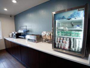 a counter with a refrigerator full of drinks at Ramada by Wyndham Coeur d'Alene in Coeur d'Alene