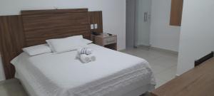 Ένα ή περισσότερα κρεβάτια σε δωμάτιο στο Hotel terceiro milênio 1