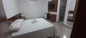 Ένα ή περισσότερα κρεβάτια σε δωμάτιο στο Hotel terceiro milênio 1