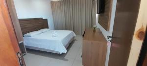 Ένα ή περισσότερα κρεβάτια σε δωμάτιο στο Hotel terceiro milênio 1 +4 φωτογραφίες