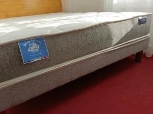 a mattress with a sign on it in a room at Appartement sur la route touristique du champagne in Sézanne