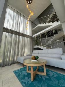 a living room with a couch and a table at LaCelia SantaVeronica in Santa Veronica