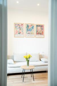 a living room with a couch and a table with flowers at Casa Lina in Trieste